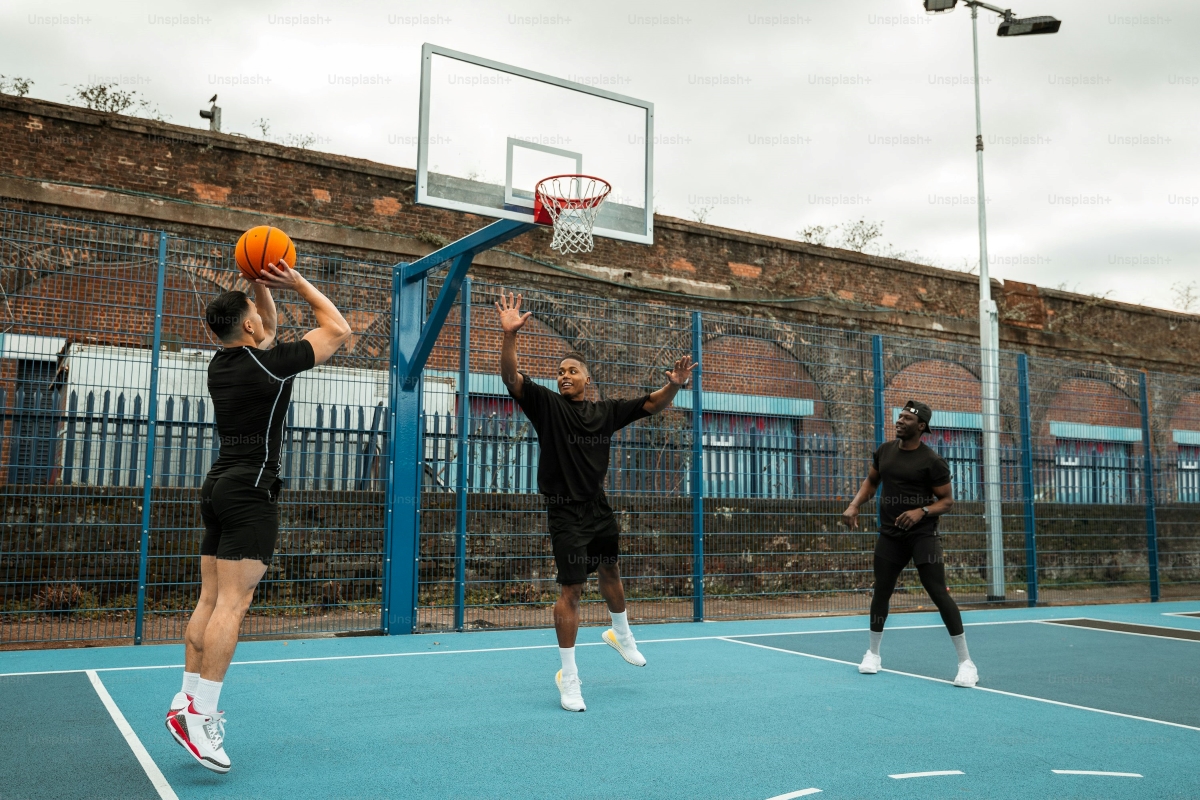 3-point: 3 players playing basketball on an outdoor court