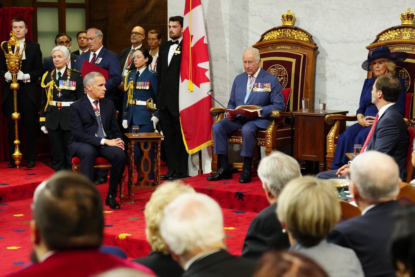 Last quarter: King Charles and Queen Camilla preparing to read the Speech from the Throne in Canada's Parliament on 2025-05-27. Prime Minister Mark Carney is seated to their right.
