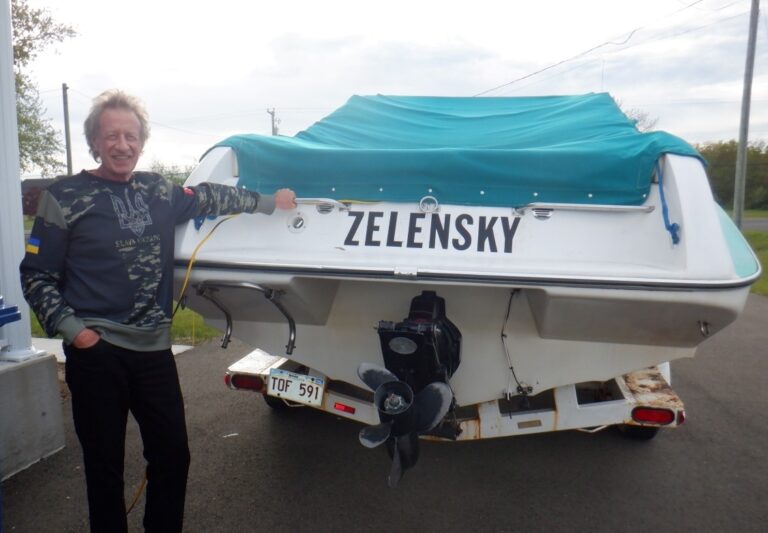 boat: author leaning on stern of his boat named Zelensky