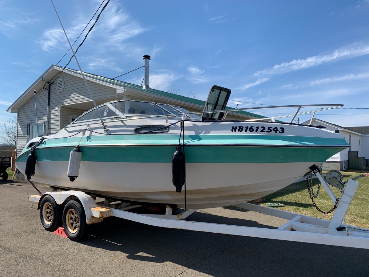 Boat: front starboard quarter view of author's former green and white sterndrive