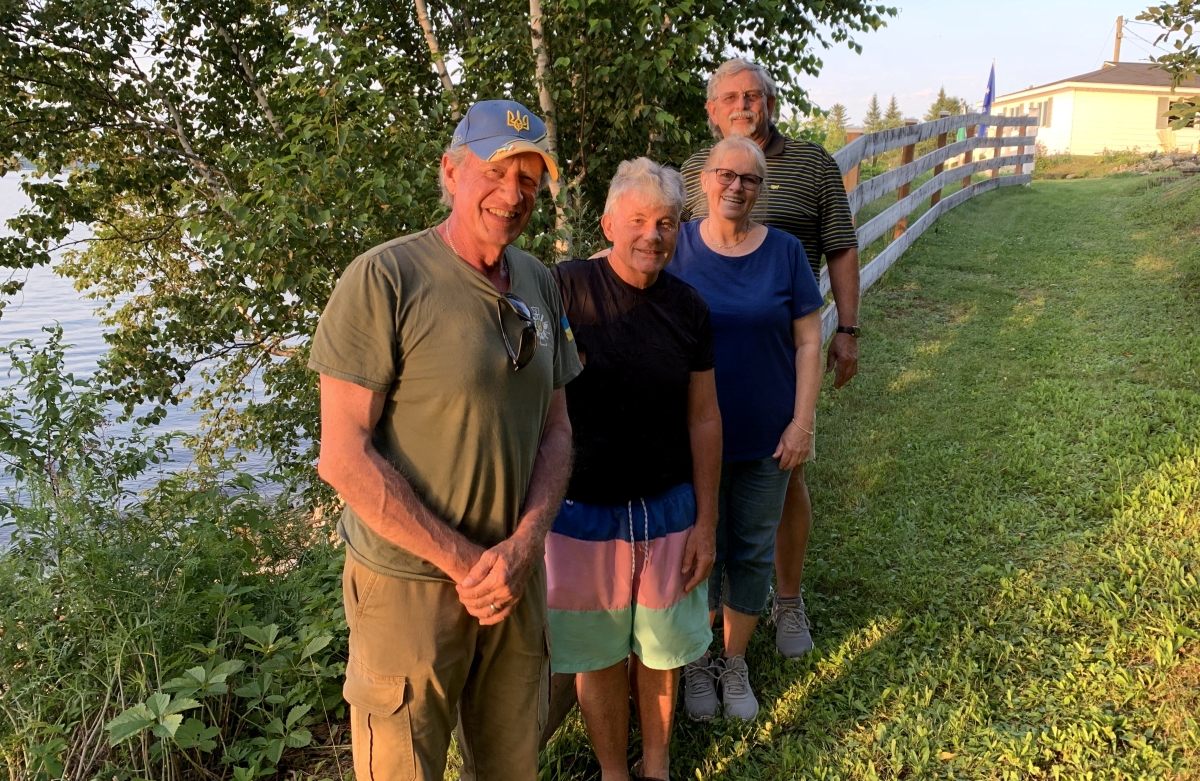 friendship - author and 3 friends in a pleasant green area on the south bank of the Miramichi River