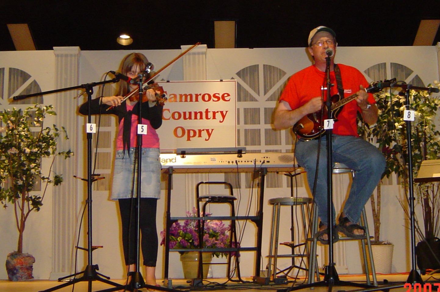 Child-centred: Author's daughter playing violin and author playing mandolin on stage at the Camrose (Alberta) Country Opry in 2007
