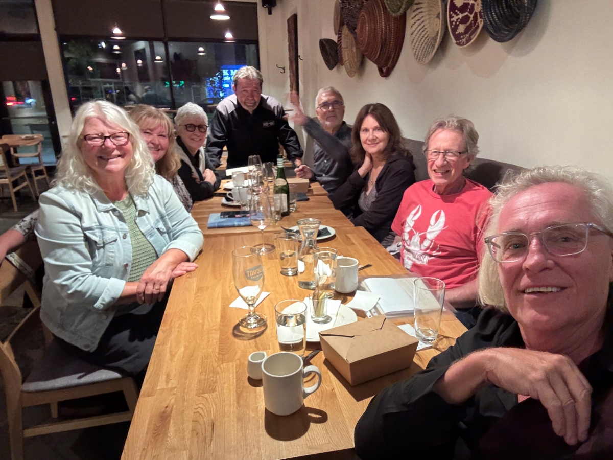 Reconnecting: 8 people sitting around a table at a restaurant