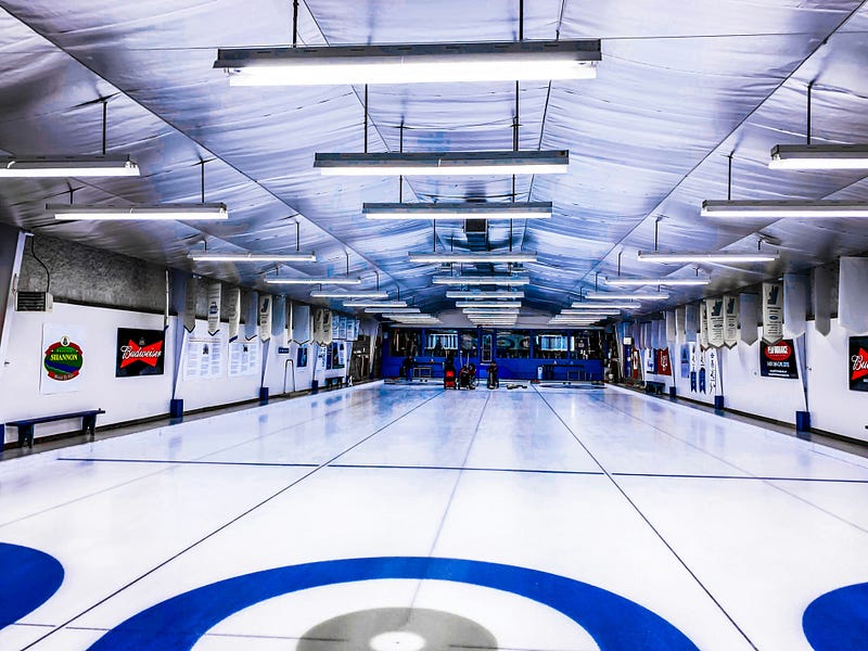Competition: the interior of a typical small-town curling rink, with 3 sheets