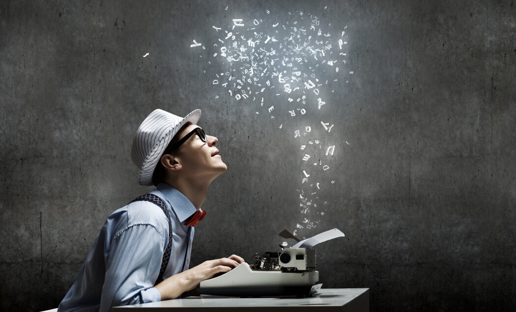 writer - man at a typewriter with lights emanating from it